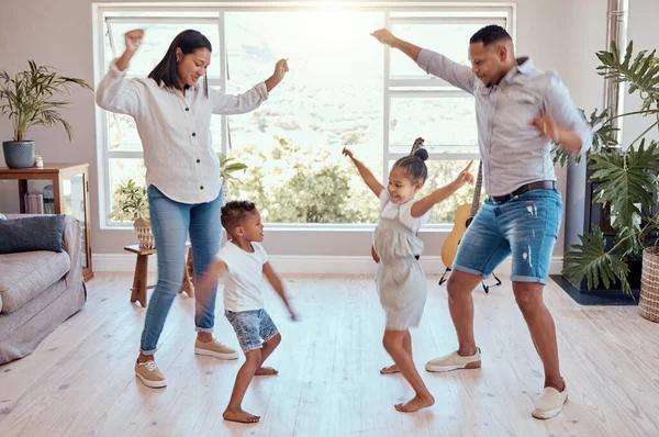 Family, dance and house for freedom and carefree fun bonding while being playful, silly and goofy. Playing, mother and father dancer and dancing with children, brother and sister in family home.