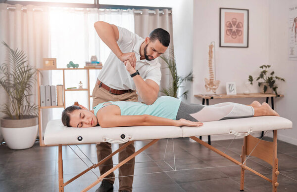 Physiotherapy, back massage and woman in hospital for health, rehabilitation and wellness. Physical therapy, help and man or nurse massaging female patient with elbow for back pain or spine injury