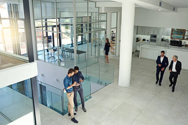 stock image Catching up before the meeting. a businesspeople at work in a large modern office