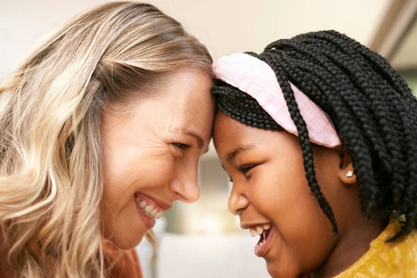 Bonding, love and girl with a foster mother for safety, care and happiness in a family home. Foster care, happy and African girl with a smile for her mom on mothers day, playful and crazy together.