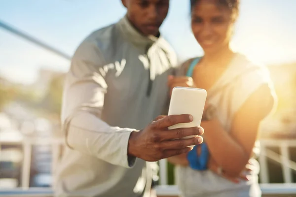 stock image Happiness is all about healthy living. a young sporty couple taking a photo together with a cellphone