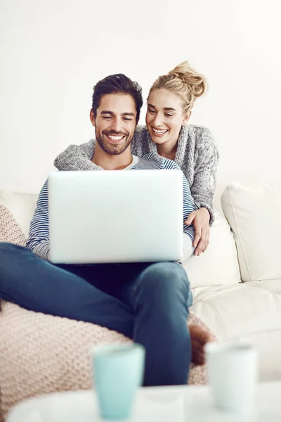 你快干完了吗 一对年轻夫妇在家里的沙发上使用笔记本电脑 — 图库照片