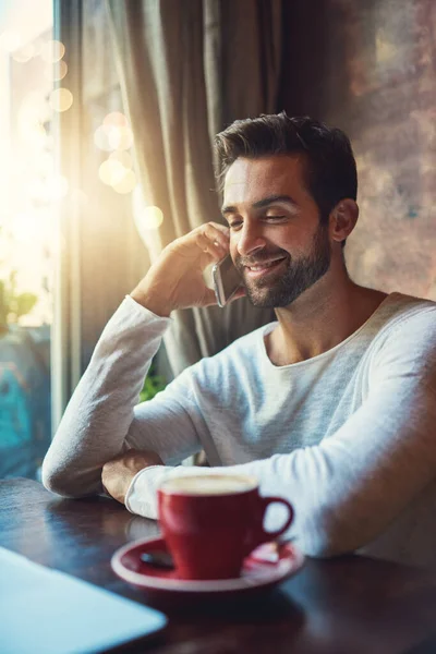 stock image Im glad you called...a young man using his cellphone in a coffee shop