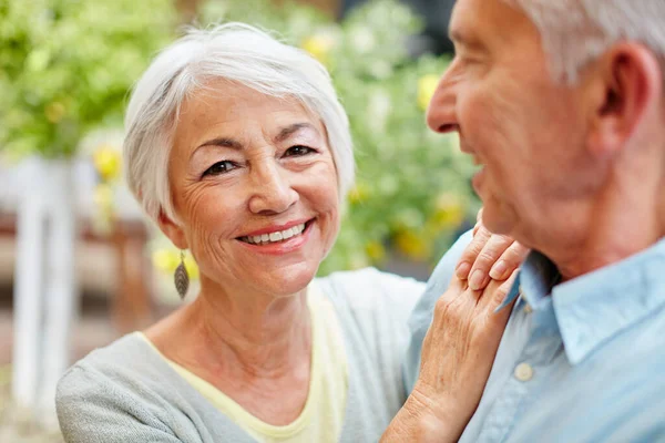 stock image We do it for the love of it. Portrait of a happy senior couple outdoors