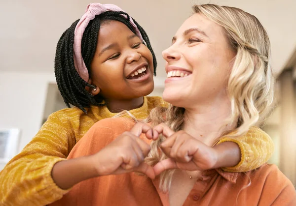 Heart sign, adoption and mother with black girl, happy together for bonding, loving and smile. Love, foster mother and daughter being cheerful, happiness and joyful to celebrate adopted child in home.