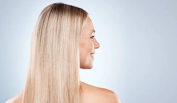 blonde happy woman, with healthy straight hair aesthetic on blue background in studio and flat iron hair care. Young girl with clean hair, side profile beauty with natural shine and luxury shampoo.