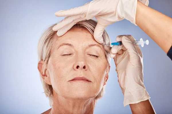 Skincare, mature woman and botox injection from healthcare professional for anti aging treatment for wrinkles on forehead. Beauty, facial wellness and a senior lady getting collagen filler injected