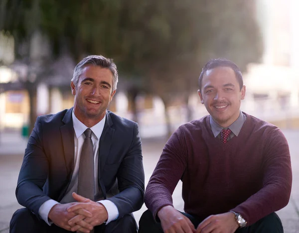 stock image Leave the talking to us. Portrait of two businessmen having a discussion while seated outside on steps