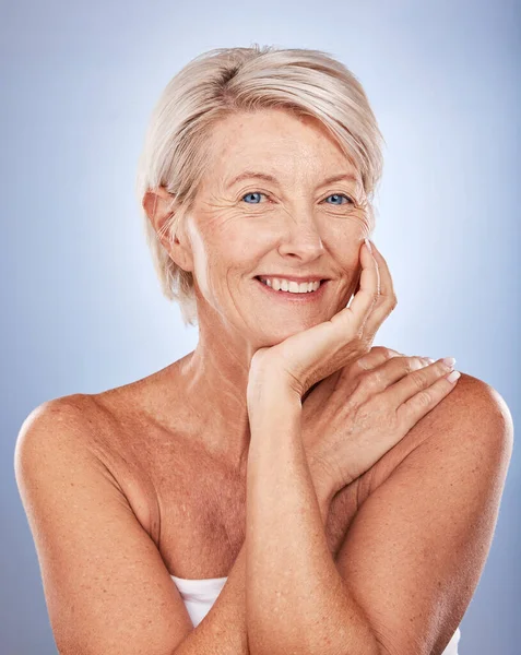 stock image Beauty, skincare and portrait of mature woman with smile on face on blue background. Health, wellness and retirement, happy senior lady with skin care facial enjoying healthy lifestyle and body care