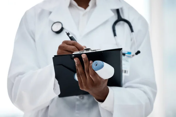 Closeup, covid and doctor with hands clipboard, writing and notes to check results, healthcare and wellness. Black medical professional, corona and analyzing diagnosis, treatment and confirm schedule.