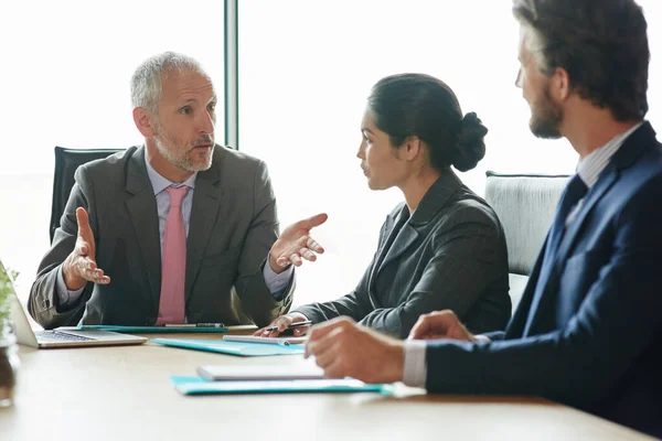 stock image Every decision they make is important. a group of executives having a meeting in a boardroom