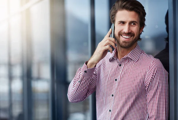 Smartphones for smart business networking. a young businessman talking on a phone outside of an office building