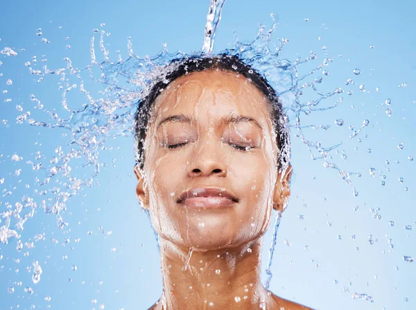 Beauty, water and splash with black woman and shower for hydration, moisture and spa luxury. Natural, fresh and hygiene with face of girl model and water drop for skincare, relax and self care.