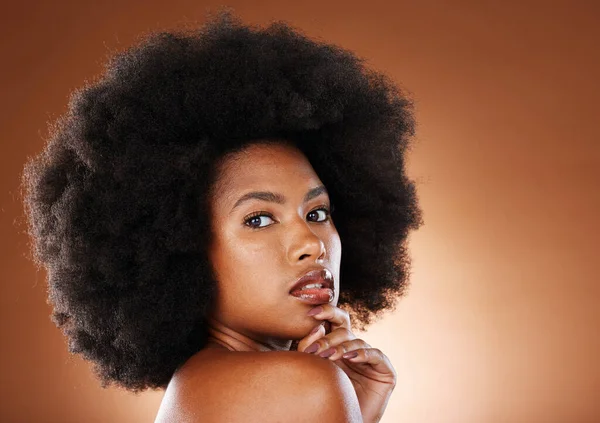 Beauty, natural hair and black woman with afro in natural cosmetics portrait, makeup advertising against studio background. Skincare, face cosmetic and hair care with glowing skin and wellness mockup.