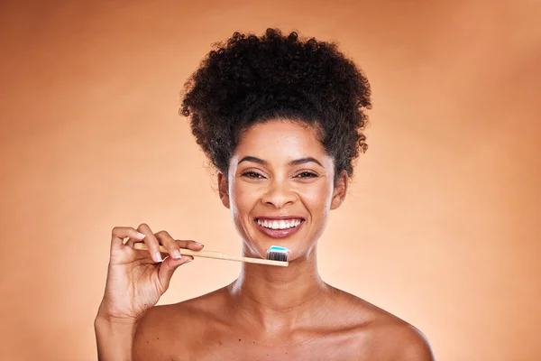 Black woman, portrait and toothbrush for cleaning, teeth and dental health or wellness on a brown studio background. Oral, health and brushing teeth with african american woman with oral hygiene.