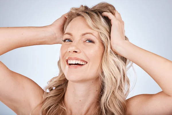 Face, portrait and hair with a model woman in studio on a gray background for natural haircare or treatment. Beauty, hairstyle and keratin with an attractive young female inside for keratin hair care.