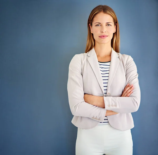 Im not here to be average. a woman dressed in office-wear posing against a blue background