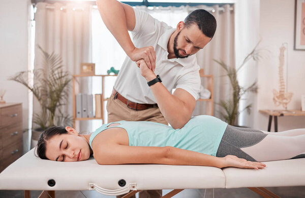 Chiropractor, massage and physiotherapy treatment for back muscle with a woman patient. Consulting healthcare, wellness and chiropractic employee in a clinic helping with healthy body balance.