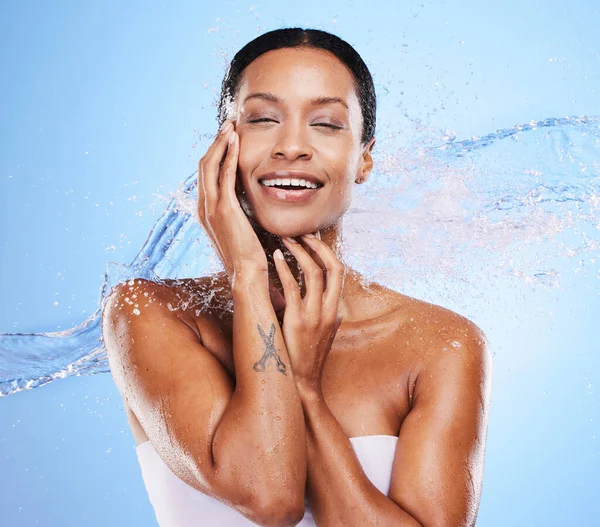 Shower, water and black woman with splash and beauty, grooming and hygiene with clean and wet against blue studio background. Natural cosmetics, fresh and hydration, wellness and healthy skin mockup