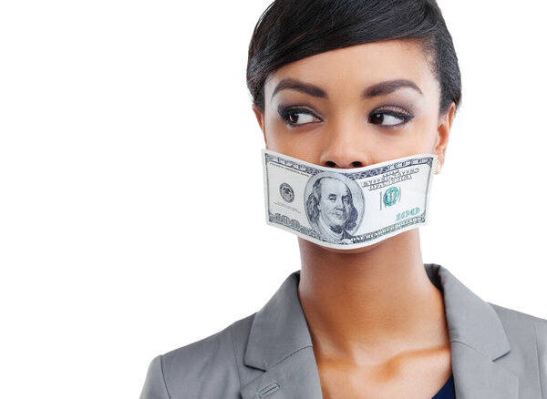 Everyone has their price. a young businesswoman standing with a 100 dollar bill over her mouth against a white background