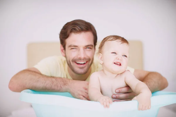 stock image Hes always there to care for her. A young father bonding with his baby daughter at bathtime