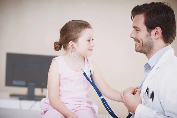 彼女は彼の聴診器を試してみる 小さな女の子は彼に彼の聴診器を使用して彼女の医者と一緒に役割を逆に — ストック写真