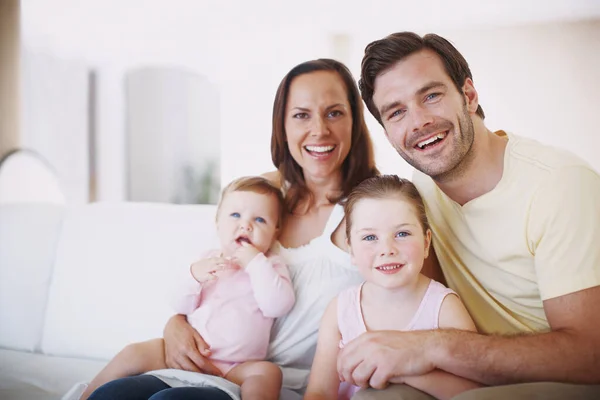 一张家庭相册 一个快乐的四口之家坐在客厅里的画像 — 图库照片