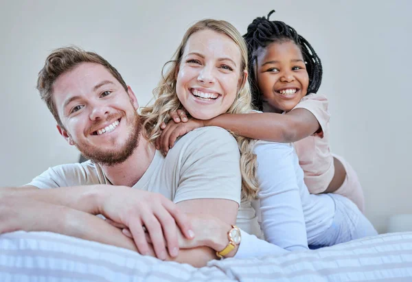 Family, parents and child in interracial portrait on bed with smile, love or happy bonding together in home. Bedroom, multicultural diversity and black girl with foster mom, dad or happy family relax.