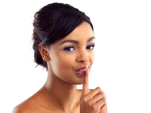 stock image Shes got the secrets to amazing skin...Studio portrait of a beautiful young woman with her finger on her lips