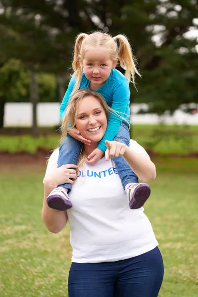 stock image We rise by lifting others. a female volunteer working with a little girl