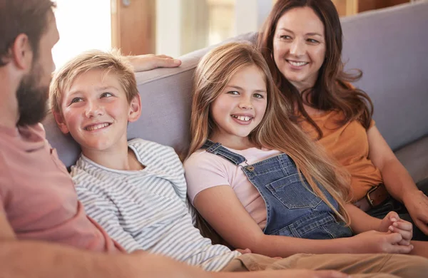 Relax, happy and smile with family on sofa for quality time, bonding and affectionate together. Weekend, rest and happiness with parents and children in living room at home for care, joy and content.