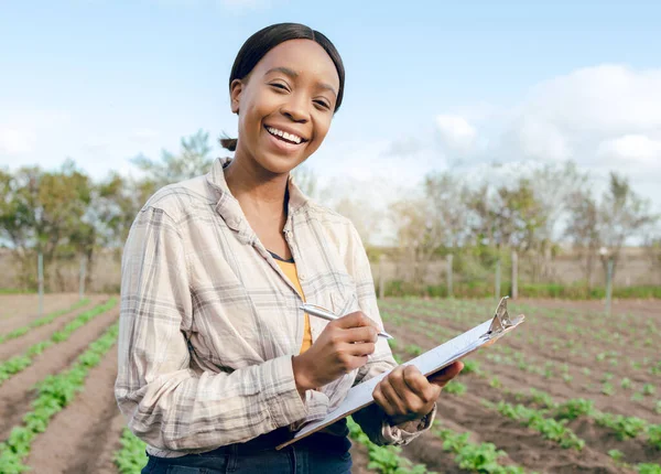 stock image Black woman, farmer and with clipboard for harvest, vegetables and check plants growth outdoor. Portrait, agriculture and female confirm quality control, farming or produce for health or eco friendly.