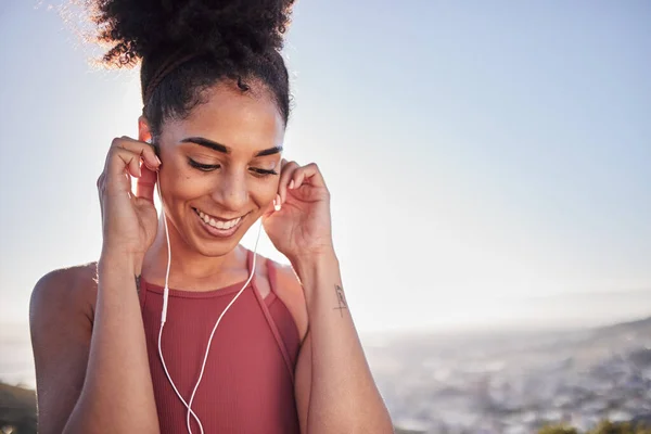 stock image Radio, workout and woman in city for running, exercise and fitness training while listening to wellness audio track. Podcast, runner and black woman workout at sunrise, happy and excited by music.