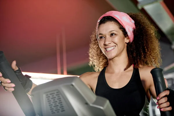 Every workout is worth it. a young woman working out with a stepping machine at the gym