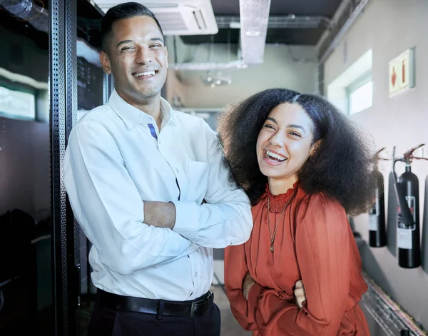 Engineer, cybersecurity and happy team together in a server room or data center for maintenance for cloud computing or information technology system. IT man and black woman, happy about teamwork.