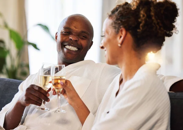 Spa, relax and couple champagne toast for happiness with marriage, love and care at luxury hotel. Wellness, happy and black people smile together for wedding anniversary celebration drinks