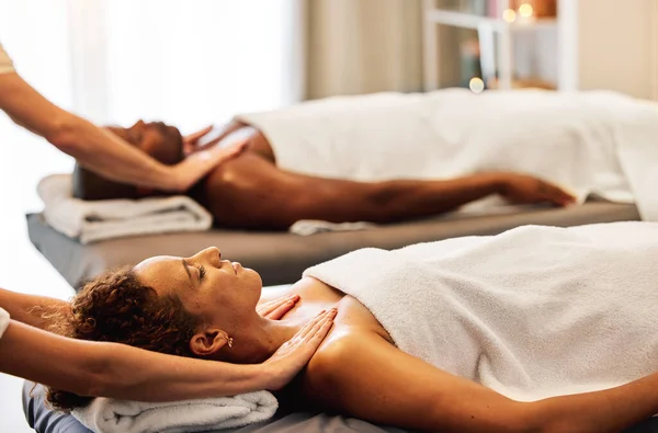 Spa, relax and couple massage for luxury wellness therapy or skincare health with masseuse hands. Zen physcial therapy, African man and woman body detox and peace at beauty salon for calm bodycare.