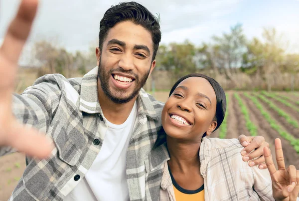 Selfie, couple and agriculture, farmer and farm with harvest and land for sustainable farming and green environment. Crop, organic and man, black woman smile in portrait, farming and sustainability