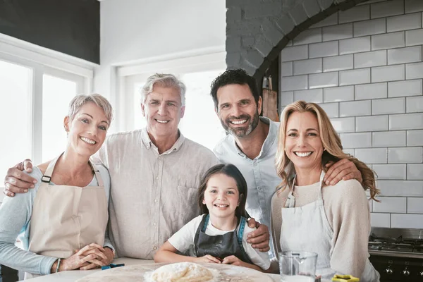 Cooking, help and portrait of big family in kitchen for happy, learning and food together. Support, smile and chef with parents teaching child baking skills with grandparents at home for cake dessert.