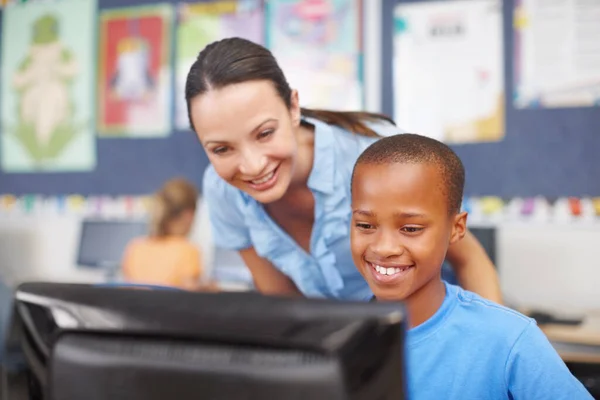 喜欢上电脑课 一个漂亮的年轻女子在计算机课上帮助一个年轻的少数民族男孩 — 图库照片