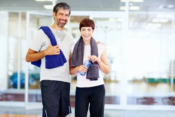 Fit couple. Portrait of fitness man and woman with hands around at fitness center