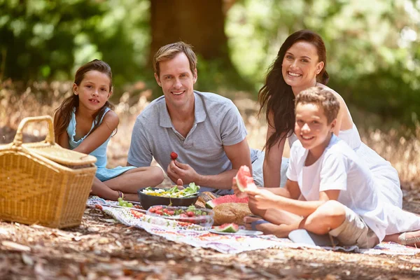 stock image This family believes in the power of happy. a happy family having a picnic in the forest