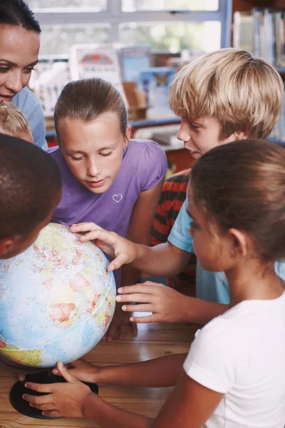 I want to travel here one day. A group of schoolchildren learning about the world with their geography teacher
