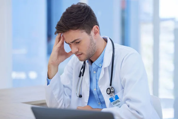 Man, doctor or stress headache in hospital data analysis, test results analytics or surgery planning. Thinking healthcare worker, anxiety or mental health burnout on medical clinic laptop technology.