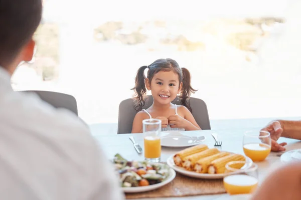 stock image Child, girl or family lunch meal at dining table for holiday celebration, reunion or social gathering. Portrait, smile or happy kid with healthy food in house, home or restaurant and bonding at party.