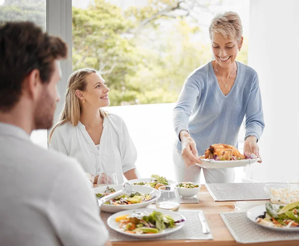 family, relax and dinner together in family home for happiness, big family conversation or healthy food at table. Happy lifestyle, women and man smile, eating lunch and luxury celebration in home.