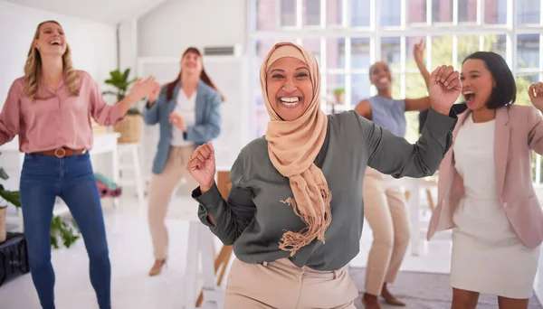 Business women, dance and success, diversity and teamwork, happy celebration and achievement, goals and winner dream. Collaboration, energy and excited employees dancing with muslim manager in hijab.