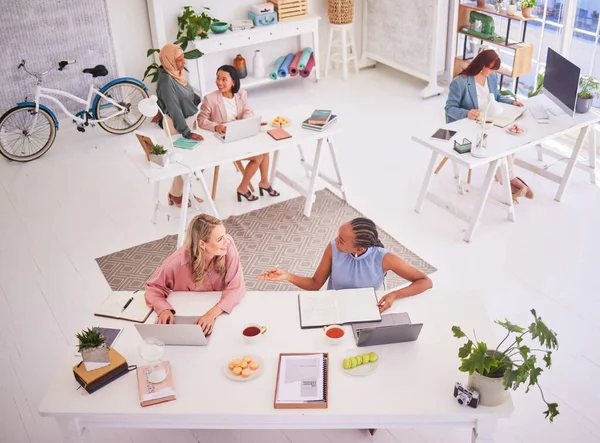 stock image Creative, office and aerial of people, working in design studio for marketing company. Teamwork, startup and top view group of business women sitting at desk in eco friendly and creative workplace.