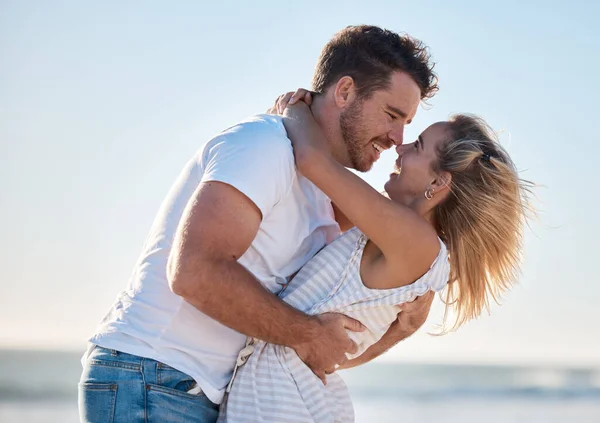 stock image Couple, hug and love, happy at the beach with relationship and romance for bonding and together outdoor by the ocean. Romantic, care and travel date with man and woman hugging and quality time