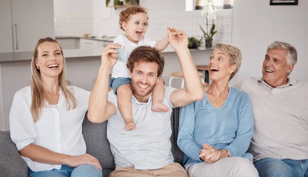 stock image Playful, portrait and big family on the living room sofa during a visit from grandparents. Love, smile and baby bonding with his parents and senior man and woman on the couch in happiness together.